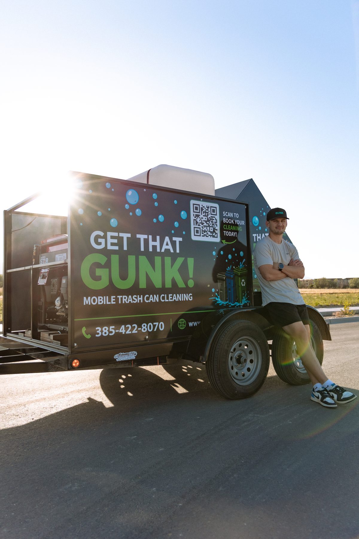 Get That Gunk owner Jimmy standing beside the mobile cleaning trailer
